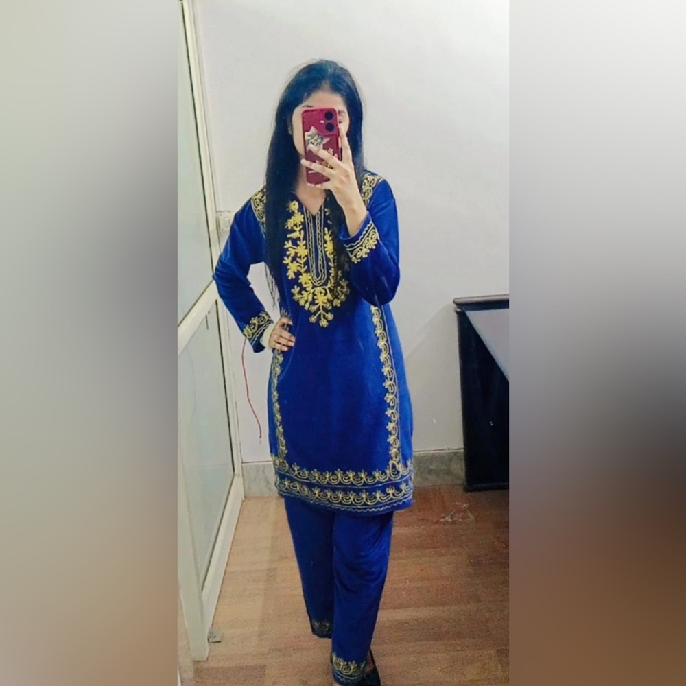 Blue velvet coord set with yellow embroidery.